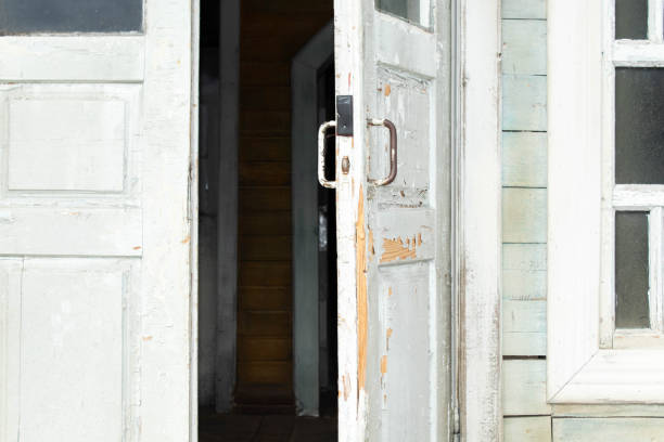 istock Grey retro style wooden door on gery cement wall background. 1447005734
