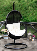 istock A rattan swing seat on the riverside patio. Rocking armchair. 1447005920