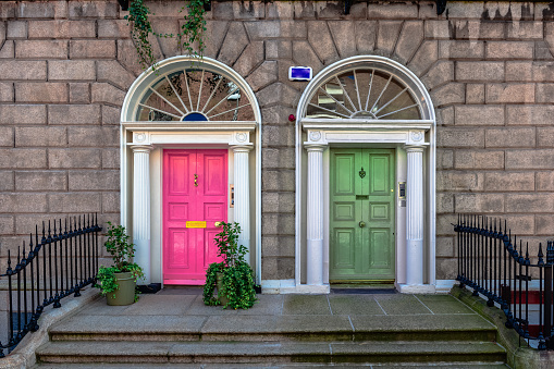 Dublin, Ireland - September 16 2022: Detail of the façade of Georgian building in Fitzwilliam pl. Colorful doors have become a trademark of the city.