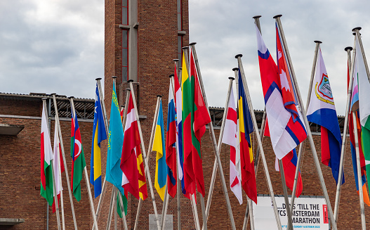 Amsterdam, Netherlands - October 14, 2022: A picture of many country flags in front of the Olympic Stadium as part of the 2022 edition of the Amsterdam Marathon.