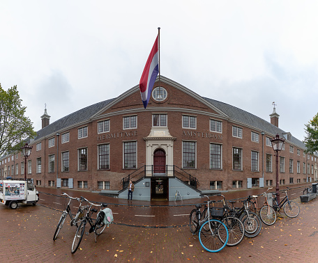 Amsterdam, Netherlands - October 15, 2022: A picture of the Hermitage Amsterdam museum and multiple bikes in front of it.