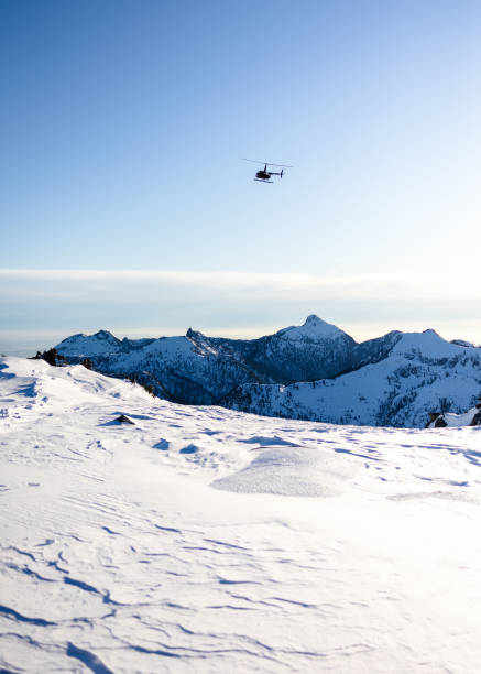 istock R-44 Helicopter Flying Over Snowy Mountain - Colour 1447007738