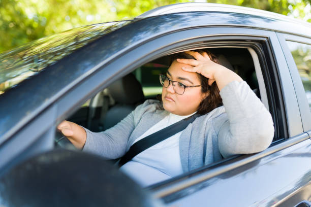 istock Tired upset woman driving with traffic 1447008586