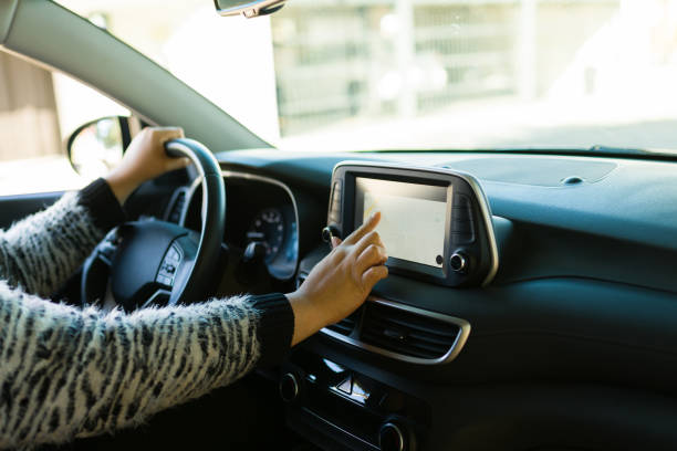 istock Woman driver getting directions while driving with GPS 1447008753