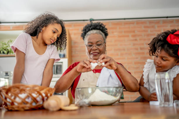 istock Grandma and granddaughters making Christmas cookies 1447009320