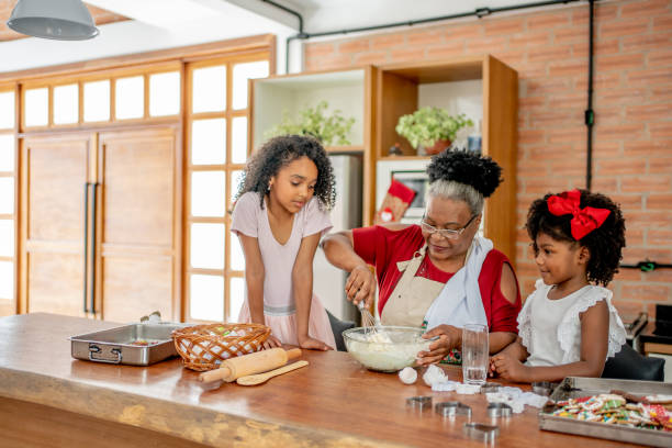 istock Grandma and granddaughters making Christmas cookies 1447009405