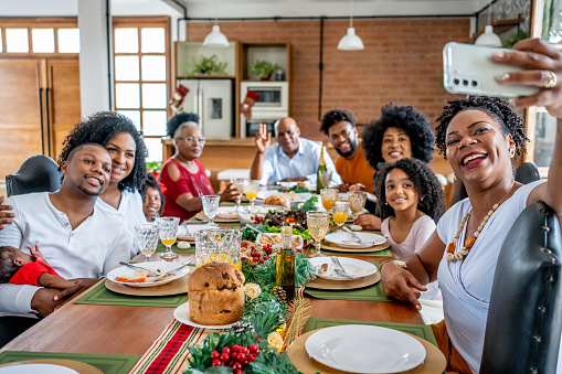 Family taking selfie at Christmas lunch at home
