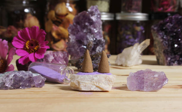 istock Amethyst Crystals With Flowers and Incense Cones on Meditation Table 1447012865