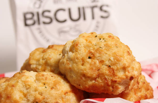 istock Fresh Garlic Cheese Biscuits With Biscuit Sign in Background Shallow DOF 1447013418