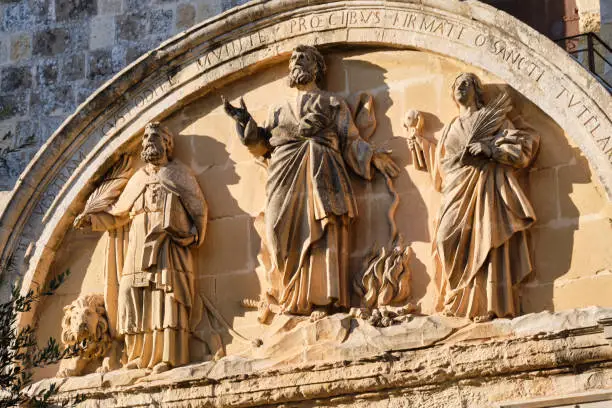 Relief on the rear of the Main Gate portraying the patron saints of Malta: St. Paul at the center with St. Publius and St. Agatha at his sides - Mdina, Malta