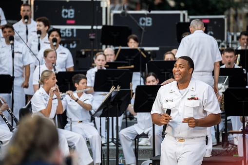 Washington, DC USA - July 27, 2021: US Navy Band singers and musicians performing a concert at the US Navy Memorial Plaza as part of the summer Concerts on the Avenue series