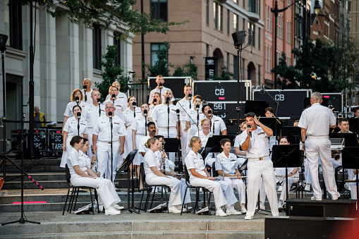 Washington, DC USA - July 27, 2021: US Navy Band singers and musicians performing a concert at the US Navy Memorial Plaza as part of the summer Concerts on the Avenue series