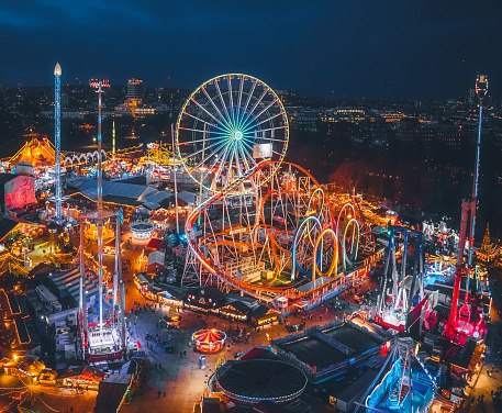 Aerial view of Christmas themed colourful amusement park and Christmas market Winter Wonderland in Hyde Park, London, UK. Destination open from November to January