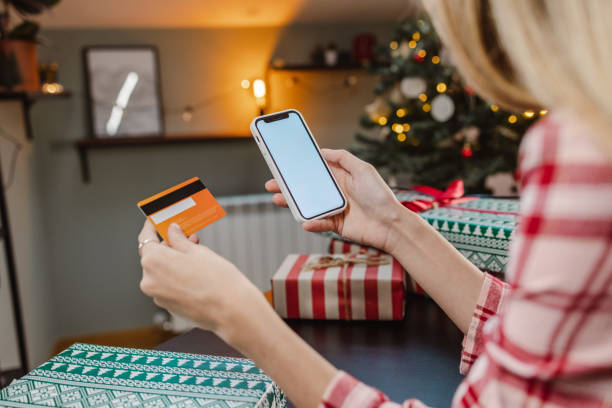 istock Beautiful woman in pajamas using online payment services 1447017750