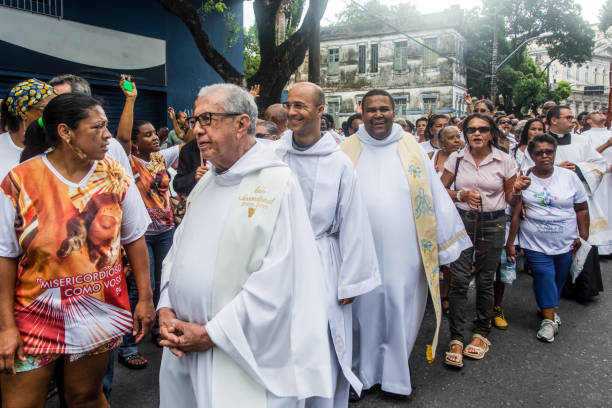priests are walking in the streets during the corpus christ procession. - confessional nun imagens e fotografias de stock
