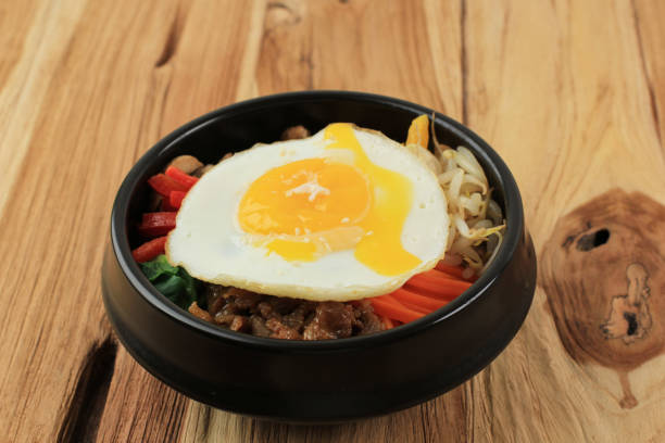 istock Bibimbap with Sunny Side Egg  on a Wooden Background 1447022197