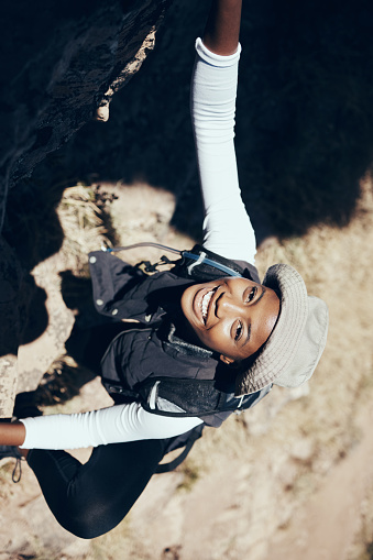 Hiking, black woman or rock on mountain for climbing, workout or fitness. Girl, health and exercise for training, sport or wellness on adventure in nature in summer on hill, hiker or stone in Canada