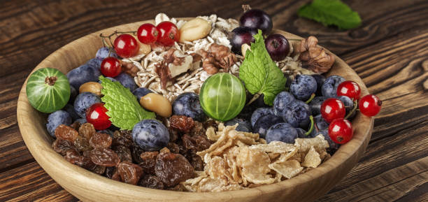 bowl of mint, nuts, berries, oatmeal and raisins.