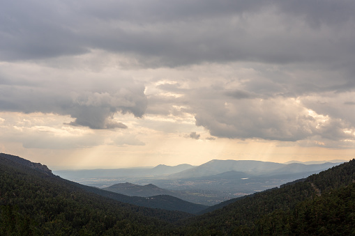 Aerial View of Valley from the Mountains with Large Storm Clouds Above