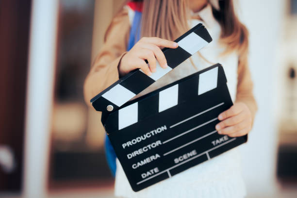 Toddler Girl Holding a Film Slate interested in Acting Lessons stock photo