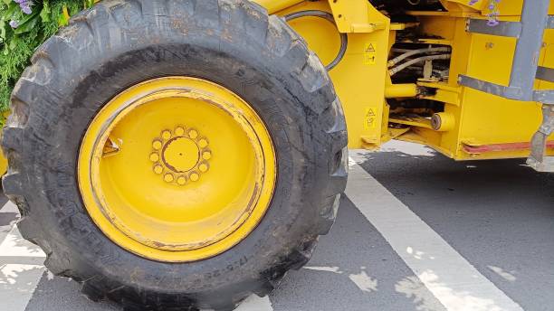 istock Close Up yellow wheels with black tires on a tractor 1447045950