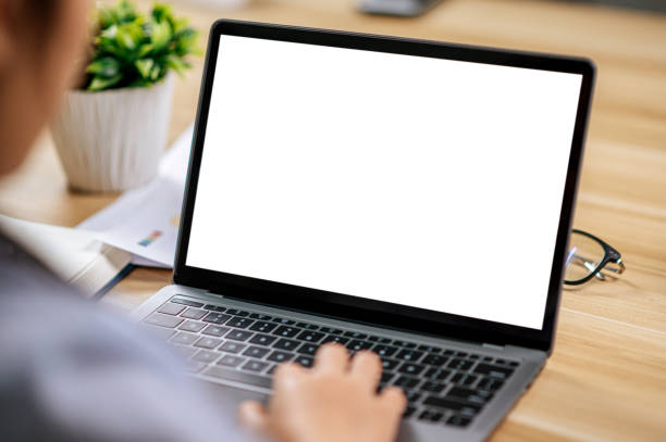 istock Young woman working with laptop computer on desk 1447049216