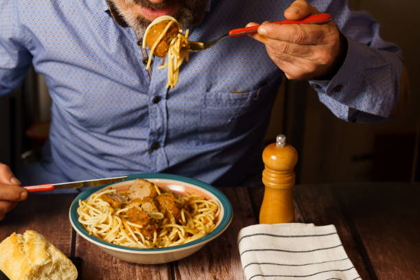 istock bearded man eating meatballs with spaghetti 1447056254