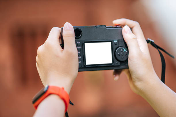istock Female photographer is holding a camera 1447057858
