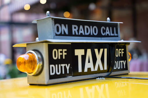 Close up of the top light of  a yellow taxi cab