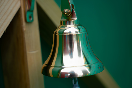 Close up of a golden brass bell.
