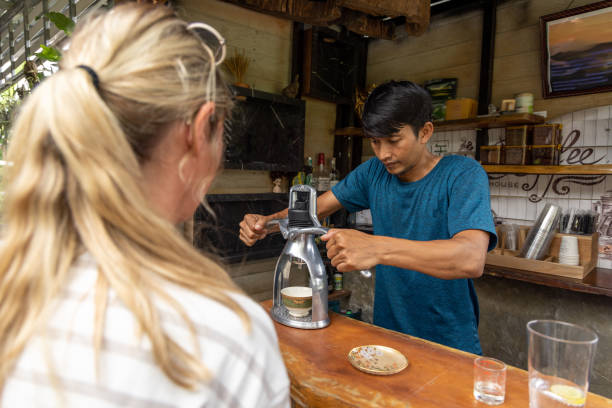 młoda kobieta pijąca espresso w lokalnej kawiarni w azji, doświadczalna podróż z różnorodnością - caffeine caucasian satisfaction small business zdjęcia i obrazy z banku zdjęć