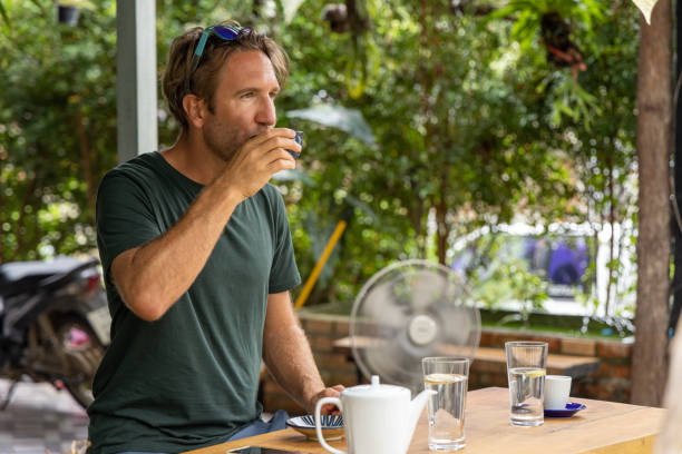 istock Young man having a tea at local cafe in Asia 1447060761