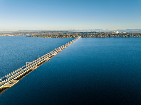 Vehicles travel across the I-520 floating bridge to Seattle.  This view is off Madison Park looking towards Medina on the east side.
