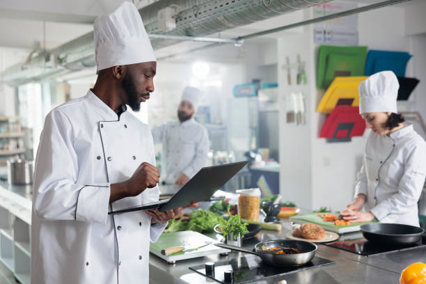 istock Gastronomy expert wearing professional cooking uniform while searching meal ideas. 1447065943