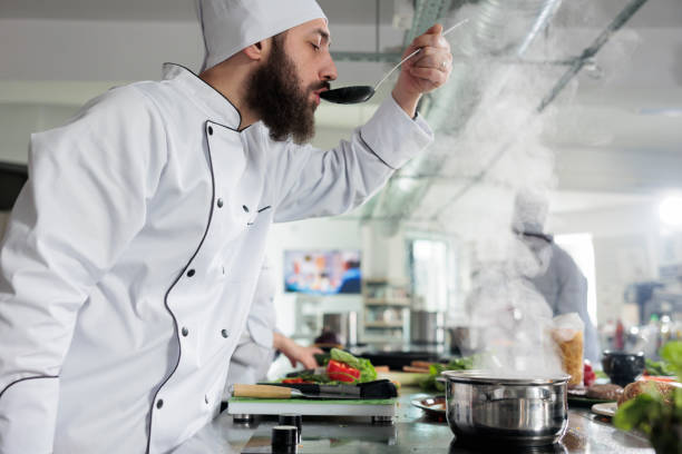 istock Gastronomy expert checking food taste before send it to customers. 1447066029