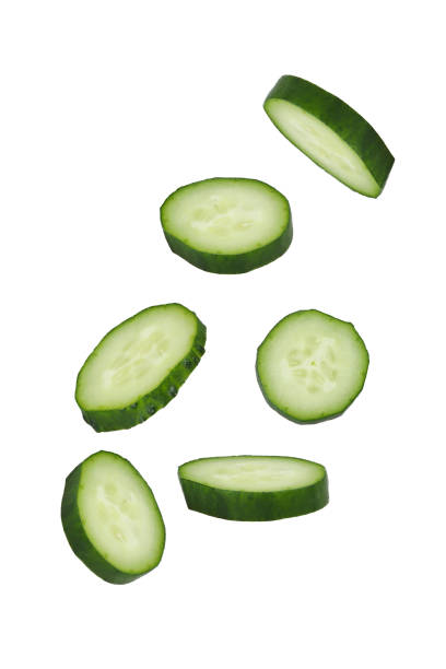 istock Soaring cucumber slices isolated on white background. 1447070530