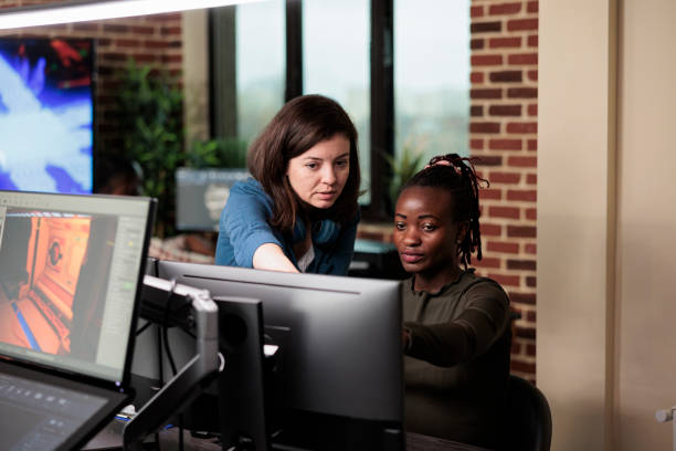 istock Company diverse employees discussing about development progress and electronic arts. 1447070633