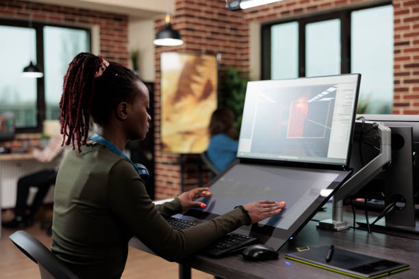 istock 3D digital artist sitting at computer desk while working on environmental design. 1447070671