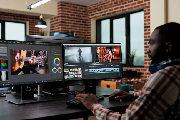istock African american creative digital video editor sitting at desk while improving recorded footage visual quality. 1447071319