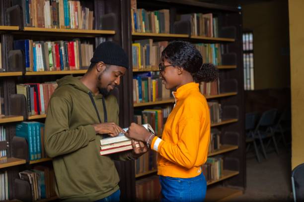istock African American students discussing books at a library 1447071629