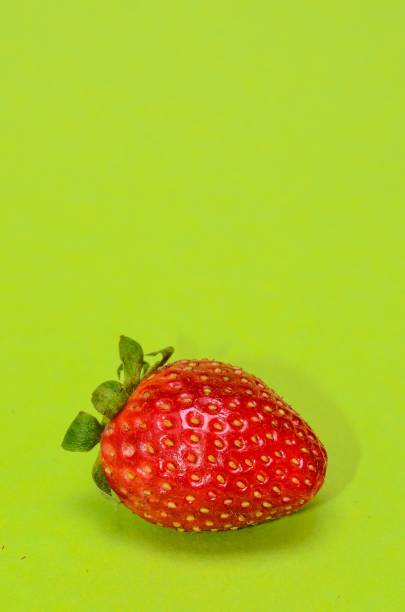 istock Fresh ripe strawberry isolated on a green background 1447071846