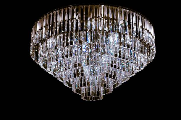 istock Beautiful crystal chandelier isolated on a black background. 1447072928