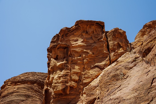Red sandstone rock formations at Wadi Rum valley in Jordan against a blue sky