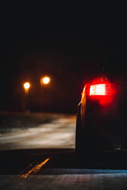 istock Vertical closeup of a car driving at night 1447075283