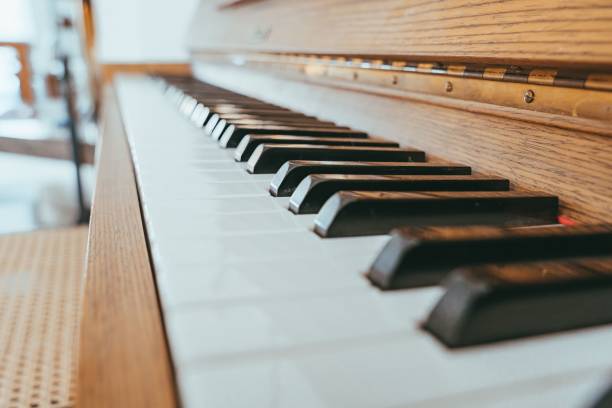 istock Selective focus on the black and white piano keys placed inside a room 1447075555