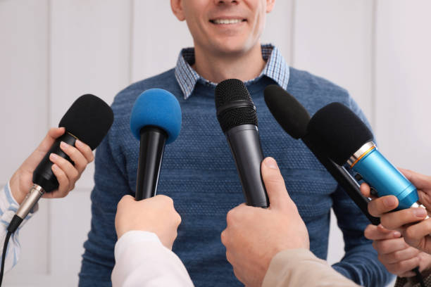 glücklicher geschäftsmann interviewt journalisten bei offizieller veranstaltung, nahaufnahme - the media paparazzi photographer press conference microphone stock-fotos und bilder