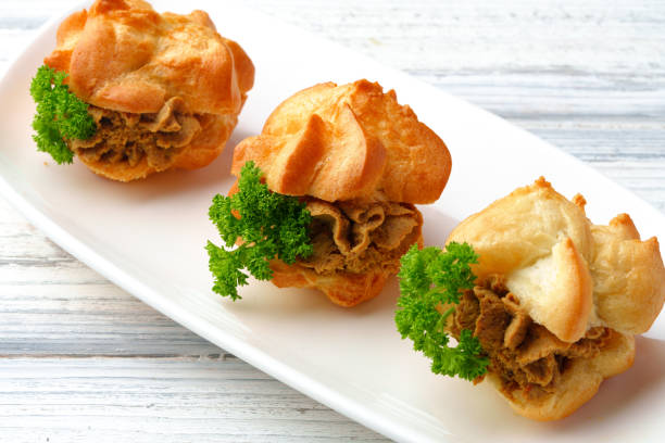 istock Profiteroles stuffed with soft mousse banquet food snacks 1447076106