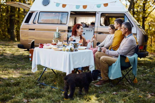 istock Happy family talking during picnic at trailer park. 1447076247