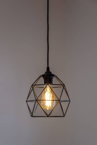 istock Black pendant lamp shade hanging on the ceiling, vertical shot 1447076499