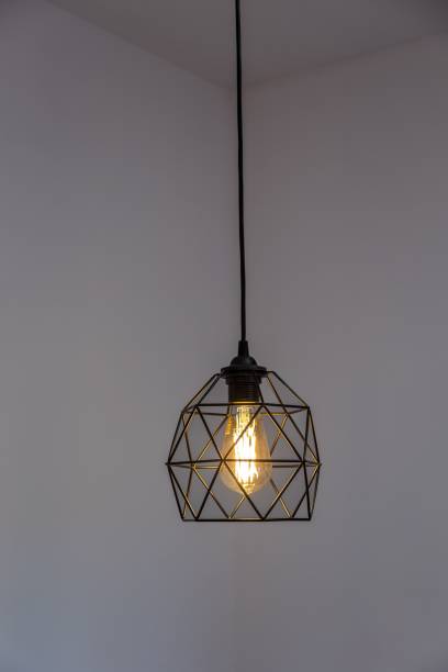 istock Black pendant lamp shade hanging on ceiling, vertical shot 1447076503